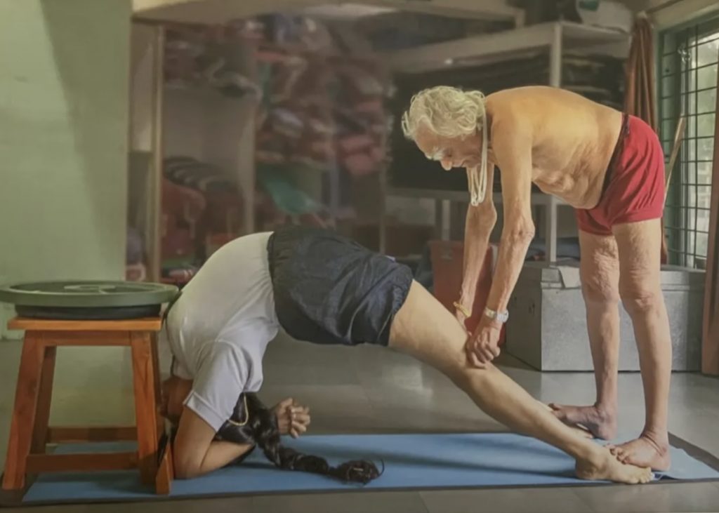 Guruji adjusting his granddaughter, Abhijata Iyengar, in Dwi Pada Viparita Dandasana